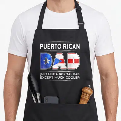Rican father day apron - Stacked text PUERTO RICAN DAD with flag filled letters and distressed brush strokes — shown on a black cotton canvas apron against a white background