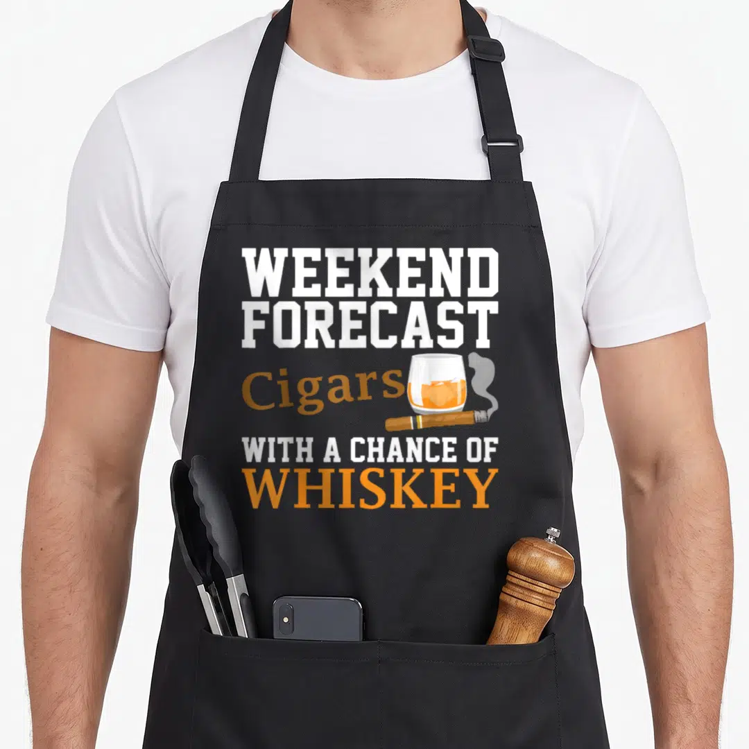 Tobacco smoker apron - Stacked text WEEKEND FORECAST Cigars WITH A CHANCE OF WHISKEY with glass and cigar — shown on a black cotton canvas apron against a white background