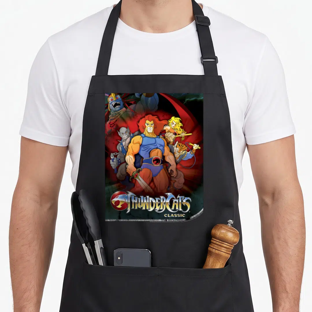 Funny poster shot apron - Lion-O central ThunderCats Classic cartoon group with red blue orange yellow villain — shown on a black cotton canvas apron against a white background