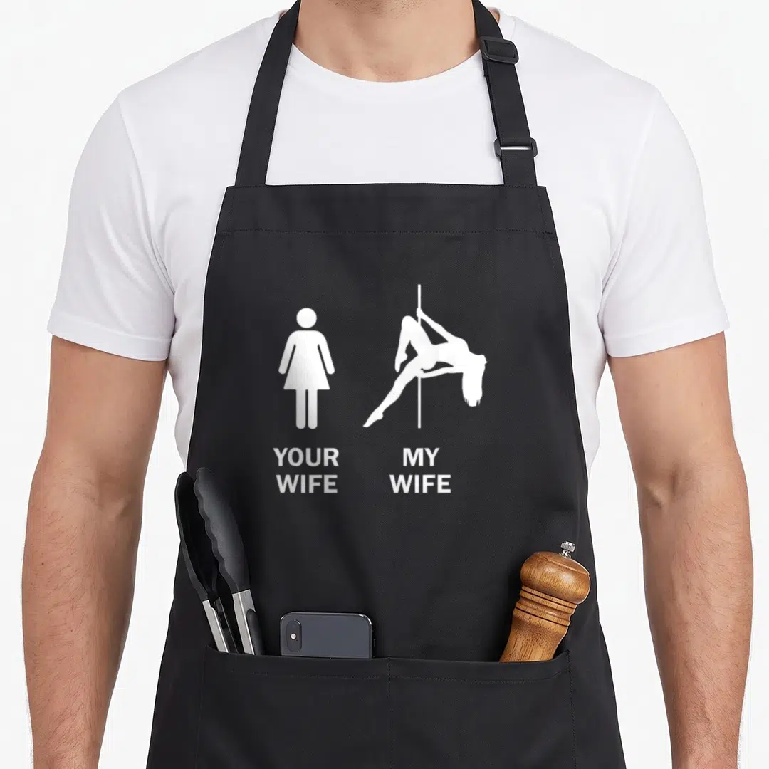 Pole wife apron - White YOUR WIFE standing icon and MY WIFE pole dancer silhouette on black bib apron — shown on a black cotton canvas apron against a white background