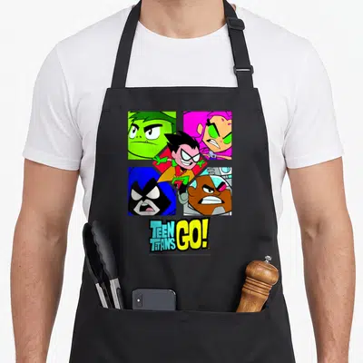 Shot box apron - Robin centered over four colored character portraits with Teen Titans Go logo below — shown on a black cotton canvas apron against a white background