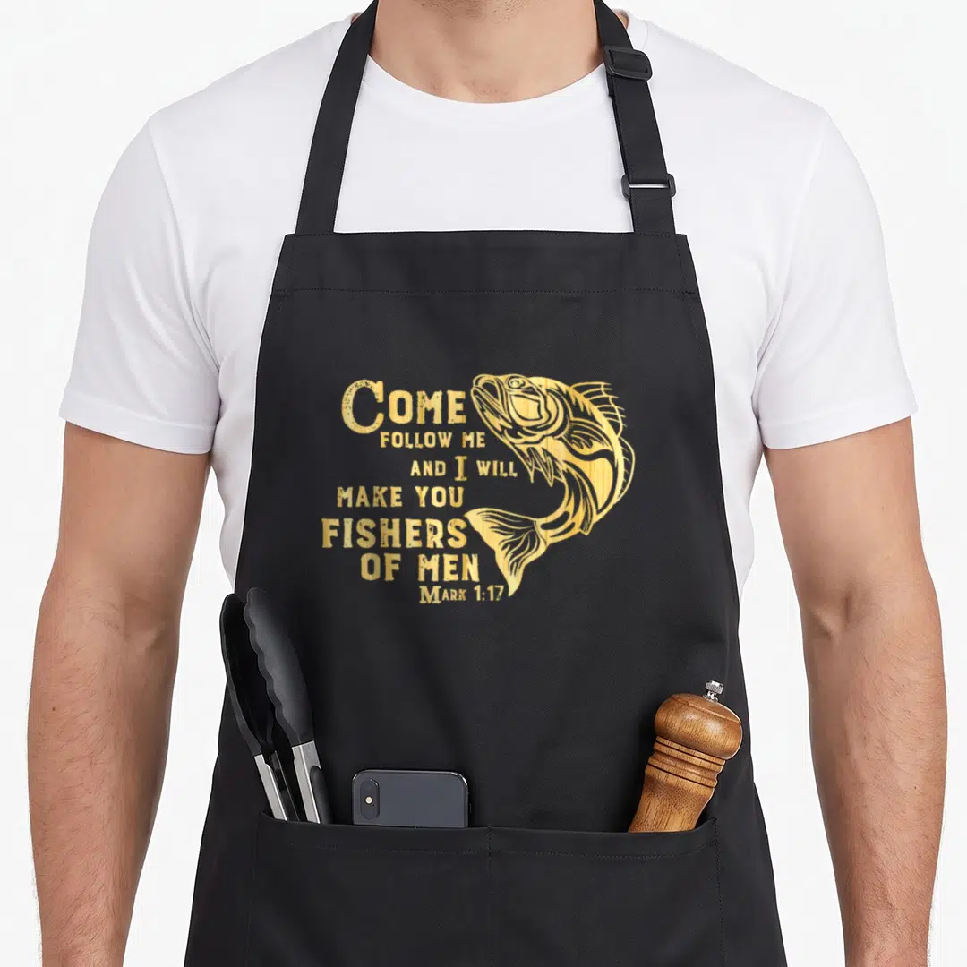 Fisher christian apron - Gold fish illustration next to stacked Mark 1:17 Bible verse text — shown on a black cotton canvas apron against a white background