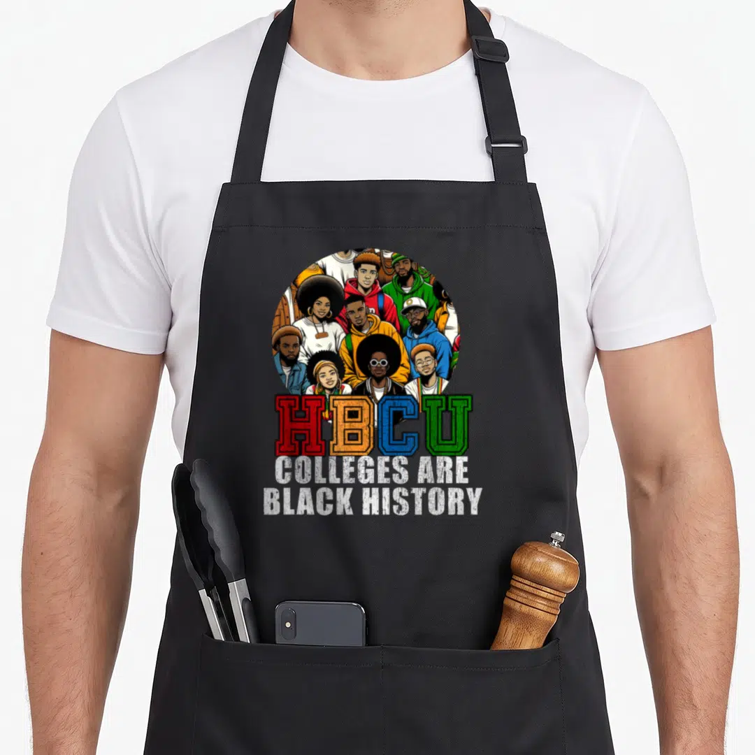 History college apron - Cartoon oval of students above HBCU text in red yellow blue and green on black fabric — shown on a black cotton canvas apron against a white background