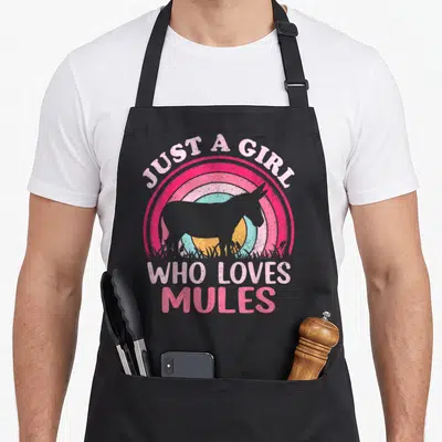 Mule apron for dad - Retro mule silhouette with rainbow background and text Just A Girl Who Loves Mules — shown on a black cotton canvas apron against a white background