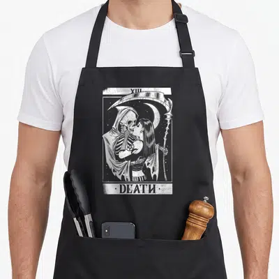 Blackcraft black gothic apron - White and grey line art of the XIII DEATH tarot card featuring the grim reaper kissing — shown on a black cotton canvas apron against a white background