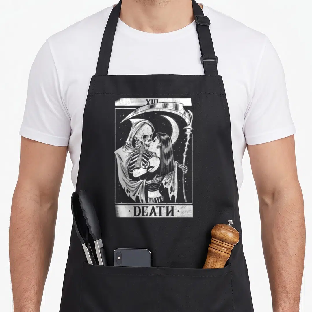 Blackcraft black gothic apron - White and grey line art of the XIII DEATH tarot card featuring the grim reaper kissing — shown on a black cotton canvas apron against a white background