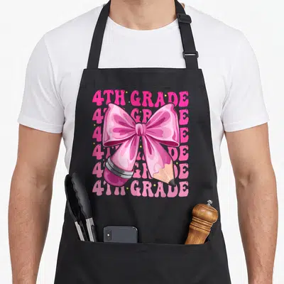 4th bow apron - Pink pencil wrapped in glossy bow with repeated 4th grade text and scattered yellow stars — shown on a black cotton canvas apron against a white background