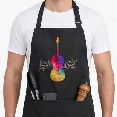Funny cello apron - Multicolored geometric cello with wavy white lines containing musical notes and stars in red blue — shown on a black cotton canvas apron against a white background