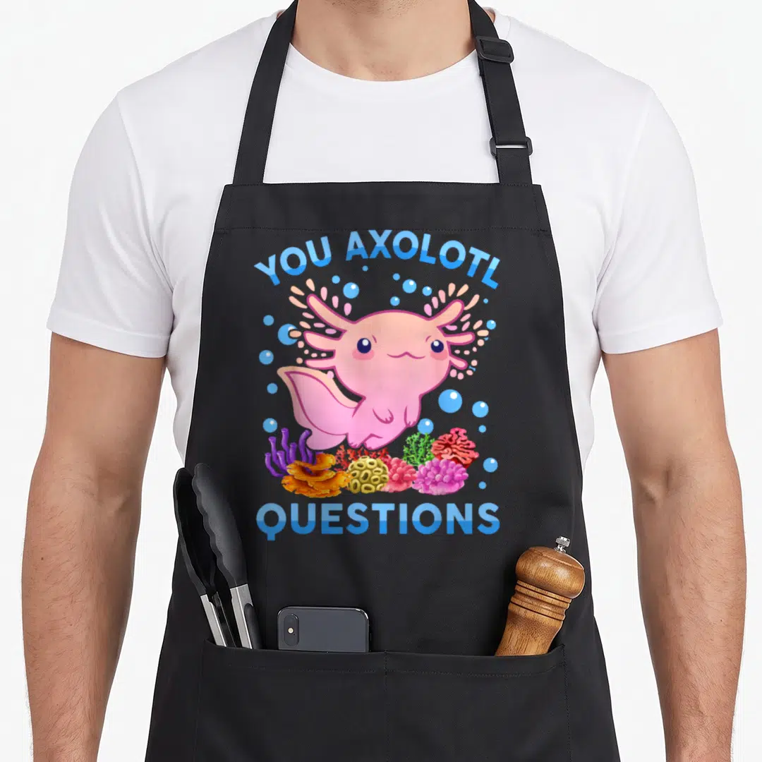 Axolotl question anime apron - Pink cartoon axolotl with blue text and colorful coral bubbles — shown on a black cotton canvas apron against a white background