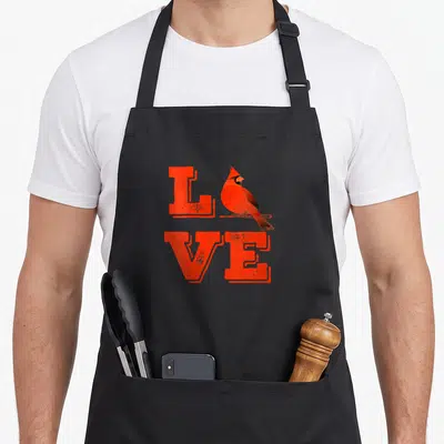 Louis missouri fan baseball apron - Red LOVE text with cartoon cardinal perched on branch replacing letter O — shown on a black cotton canvas apron against a white background