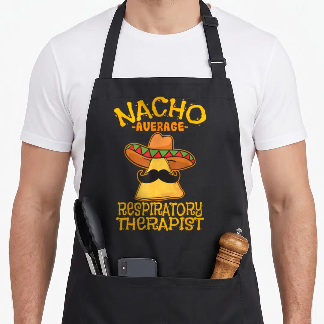 Average chips lover apron - Cartoon tortilla chip wearing a sombrero and mustache with yellow text — shown on a black cotton canvas apron against a white background