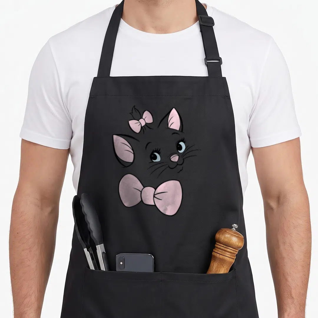 Aristocat face apron - Grey cartoon cat head with small pink head bow and large pink chin bow — shown on a black cotton canvas apron against a white background