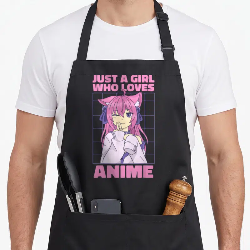 Cute otaku anime apron - Pink text reading Just A Girl Who Loves Anime above and below a winking catgirl on a purple — shown on a black cotton canvas apron against a white background