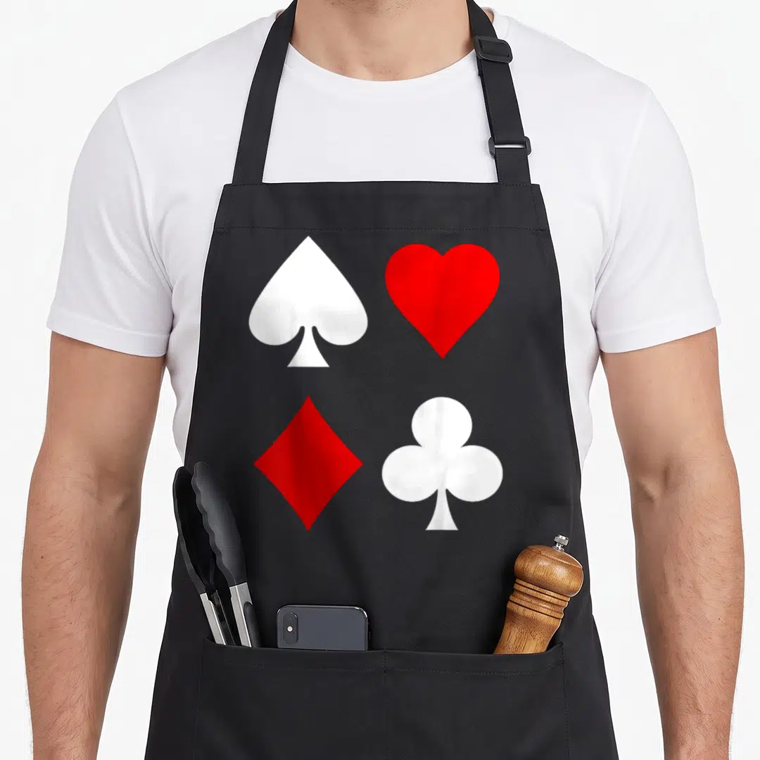Diamond poker apron - Four card suits spade heart diamond club white red grid — shown on a black cotton canvas apron against a white background
