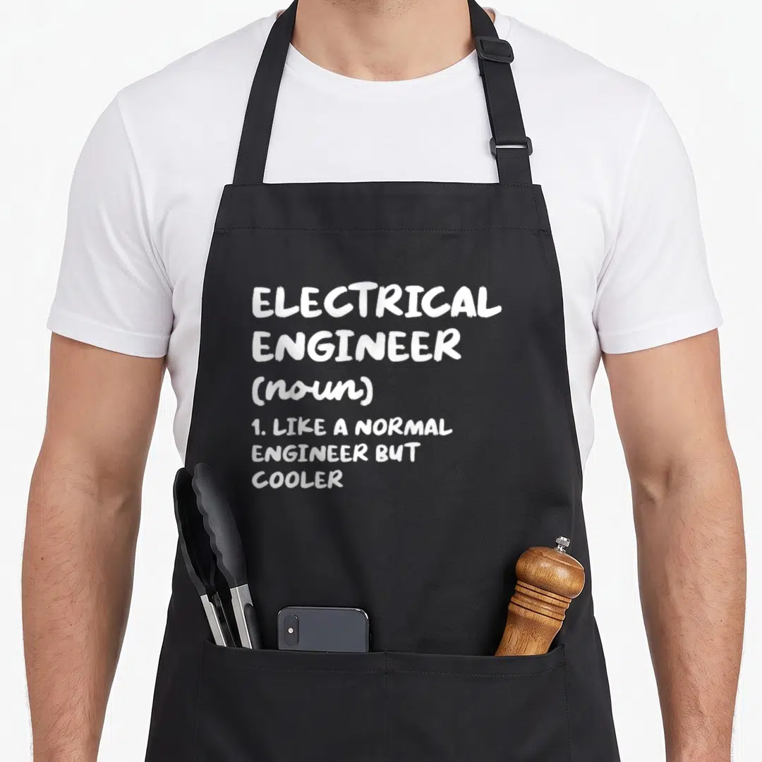 Electrical definition engineer apron - White dictionary definition text on black background stating electrical engineer — shown on a black cotton canvas apron against a white background