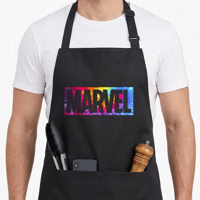Box tie apron - MARVEL text in grey over red yellow blue purple tie-dye rectangle — shown on a black cotton canvas apron against a white background