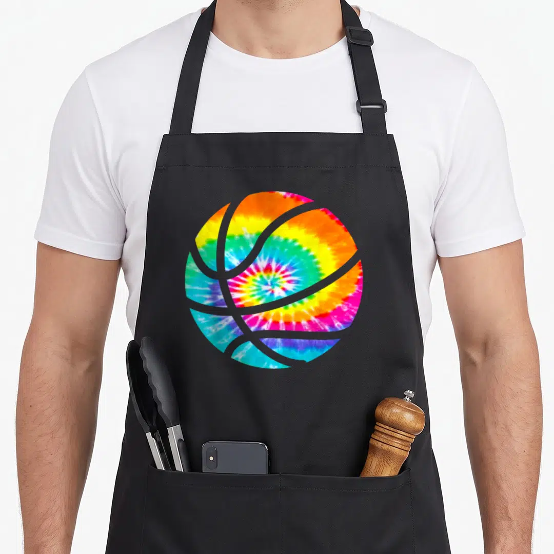 Basketball hippie apron - Rainbow tie-dye basketball graphic with spiral color swirls — shown on a black cotton canvas apron against a white background