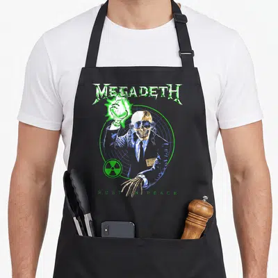 Rust heavy metal apron - Skeleton in suit inside radar target with MEGADETH text and radiation symbol — shown on a black cotton canvas apron against a white background