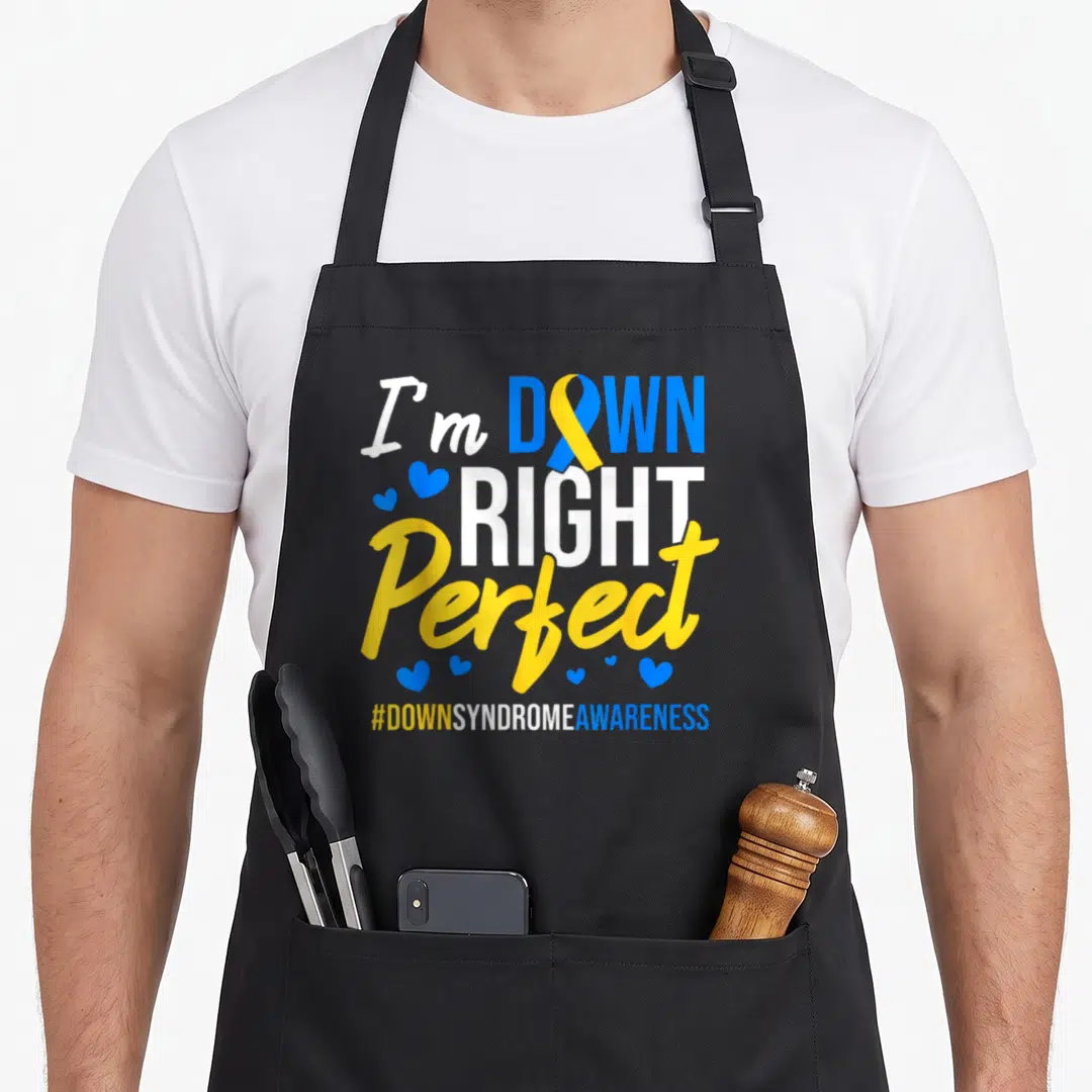Irockstar ribbon apron - I'm Down Right Perfect text with blue and yellow ribbon and hearts — shown on a black cotton canvas apron against a white background
