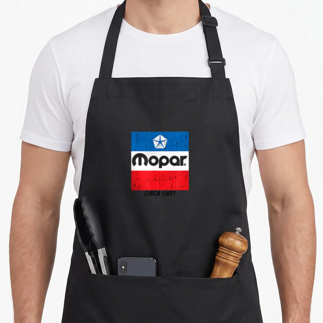 Flag challenger apron - Distressed Mopar logo on blue white and red bands with CIRCA 1937 text below — shown on a black cotton canvas apron against a white background