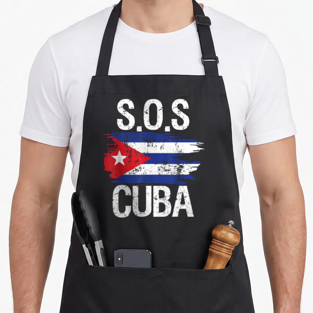 Sos cuban boy apron - Distressed S.O.S CUBA text above and below a painted Cuban flag in blue, white, and red — shown on a black cotton canvas apron against a white background