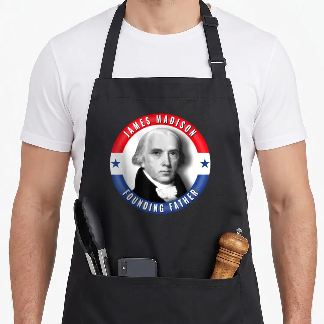 Founder patriotic apron - James Madison Founding Father portrait in red white blue circle with stars — shown on a black cotton canvas apron against a white background