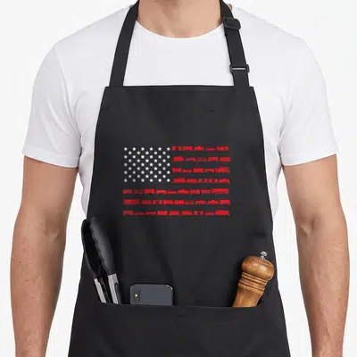 Train american flag apron - Red train rows and white stars arranged in a minimalist American flag shape — shown on a black cotton canvas apron against a white background