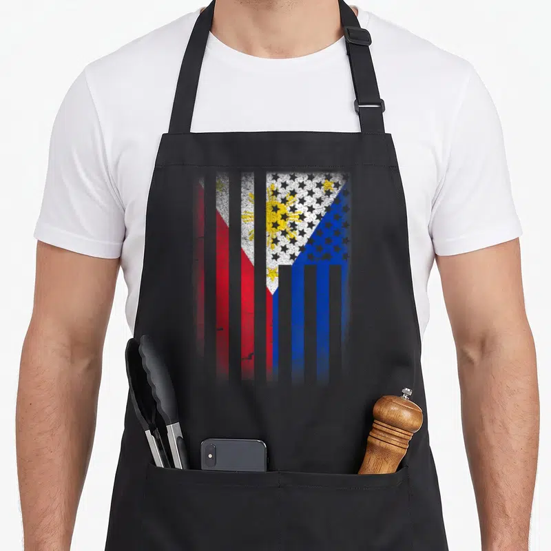 Grown philippine american flag apron - Vertical striped flag in red blue white and yellow with distressed texture — shown on a black cotton canvas apron against a white background