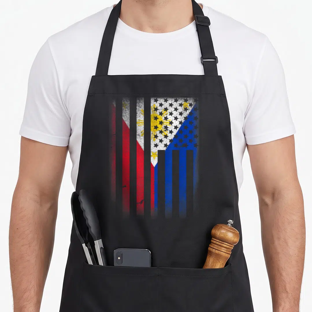 Grown philippine american flag apron - Vertical striped flag in red blue white and yellow with distressed texture — shown on a black cotton canvas apron against a white background