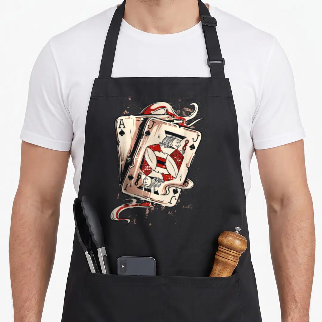 Jack ace apron - Distressed Ace and Jack of Spades playing cards with swirls in cream, red, and black — shown on a black cotton canvas apron against a white background