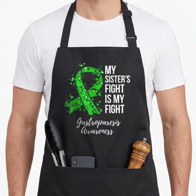 Sister gastroparesis awareness apron - Green heart awareness ribbon with My Sister Fight Is My Fight text — shown on a black cotton canvas apron against a white background