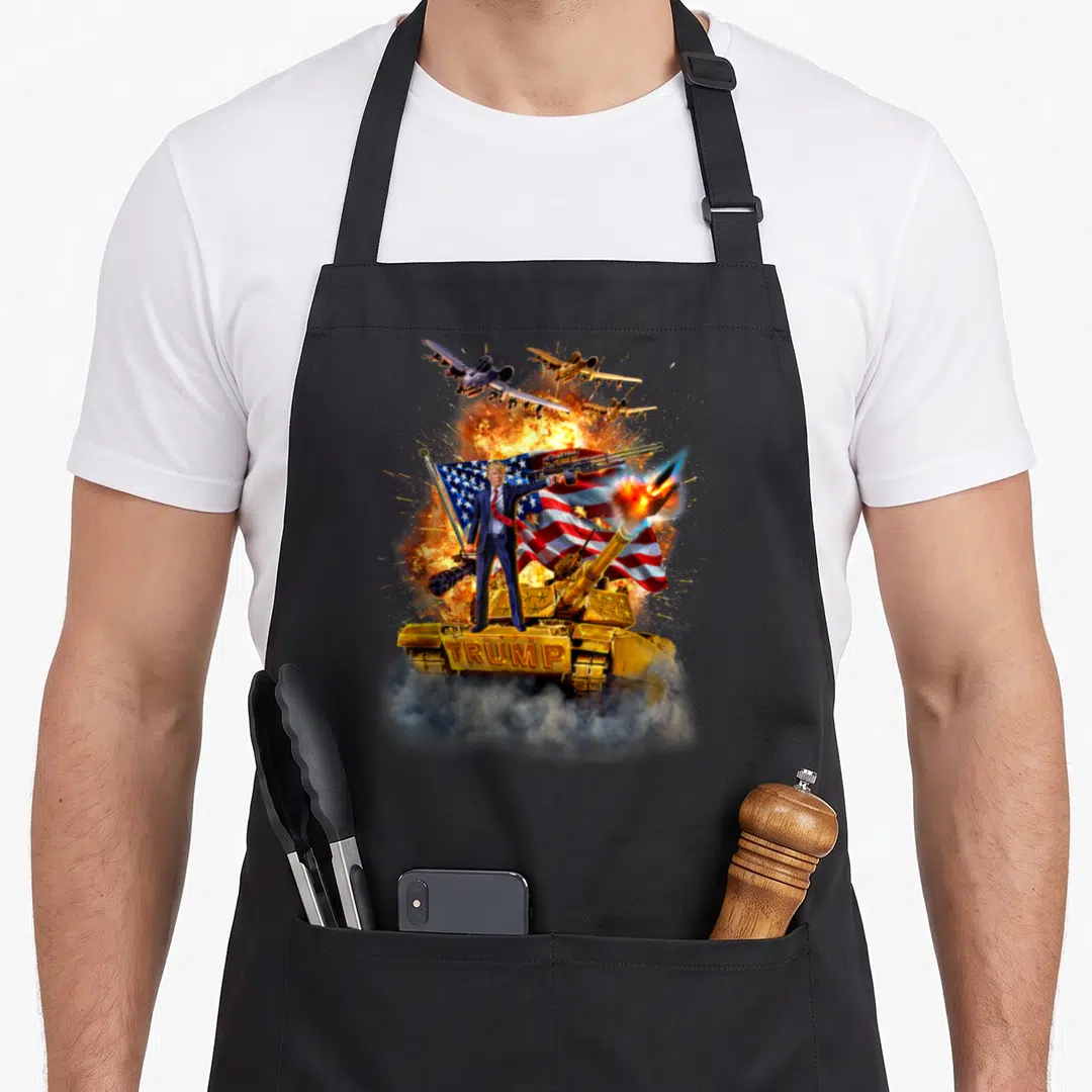 State fox republic apron - Donald Trump on gold tank with jets and USA flag explosion art — shown on a black cotton canvas apron against a white background