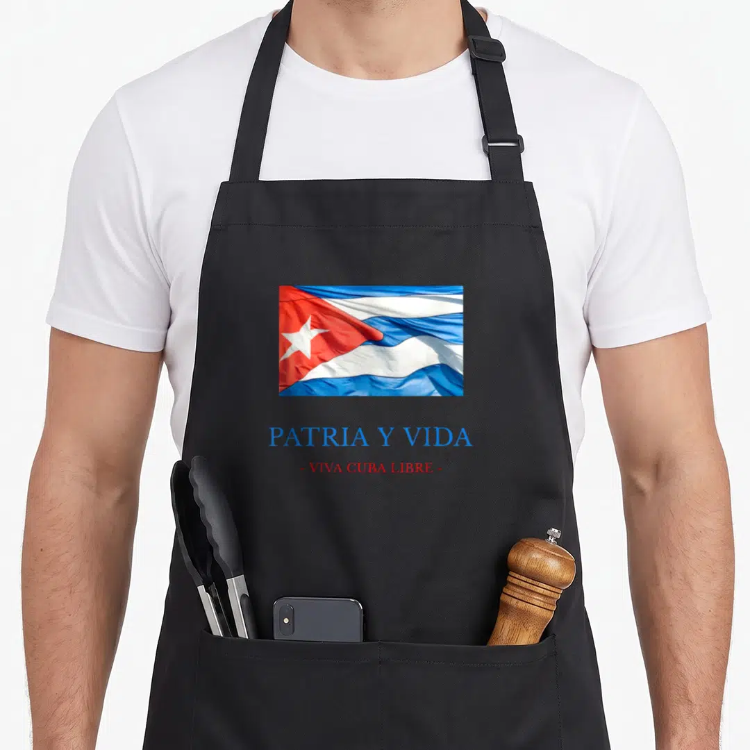 Patria cuba libre apron - Waving Cuban flag in blue white and red above PATRIA Y VIDA and VIVA CUBA LIBRE text — shown on a black cotton canvas apron against a white background
