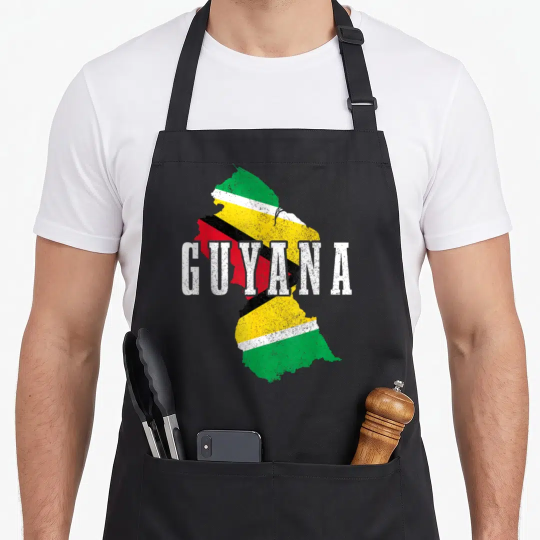 Guyana map pride apron - Distressed Guyana map filled with green yellow red white and black flag stripes — shown on a black cotton canvas apron against a white background