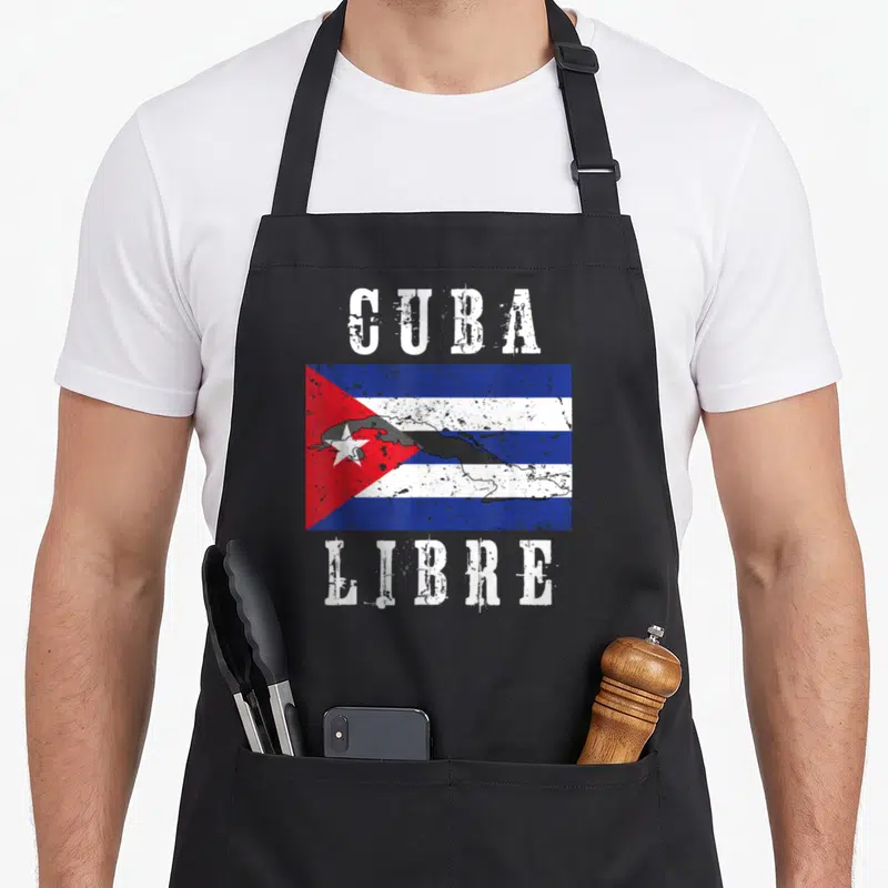Cuban flag cuba libre apron - Distressed Cuba Libre text framing a flag with a black map silhouette overlay — shown on a black cotton canvas apron against a white background