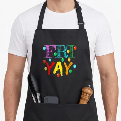 Friyay weekend friday teacher apron - FRI YAY text surrounded by purple blue green red yellow orange balloons — shown on a black cotton canvas apron against a white background