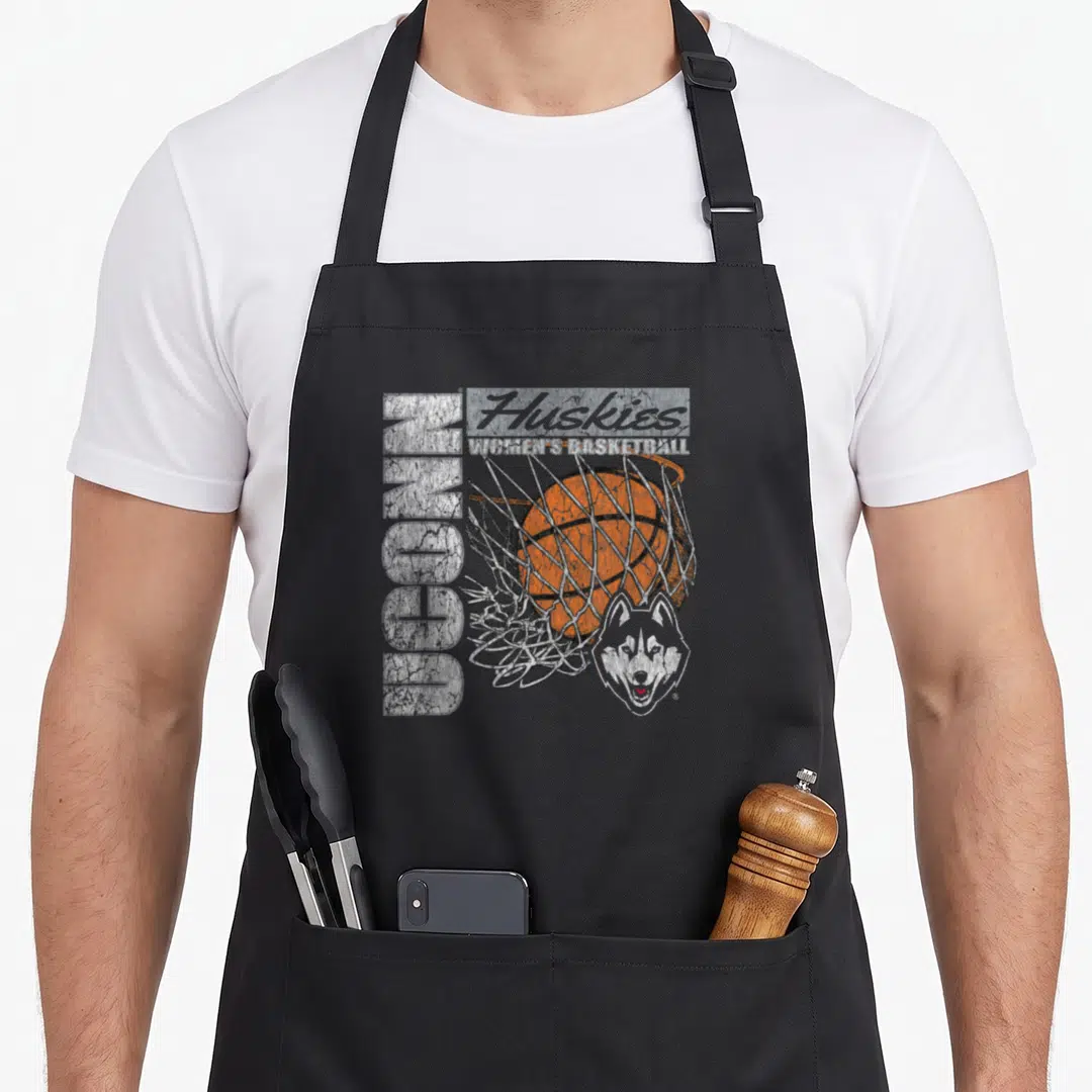 Connecticut basketball husky apron - Vertical UCONN text, stacked Huskies Women's Basketball, orange ball in net, grey — shown on a black cotton canvas apron against a white background