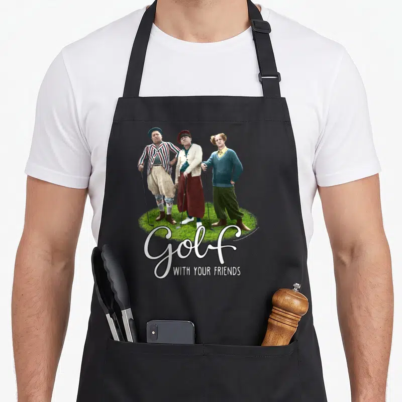 Tts golf apron - Three men on grass with Golf WITH YOUR FRIENDS text — shown on a black cotton canvas apron against a white background