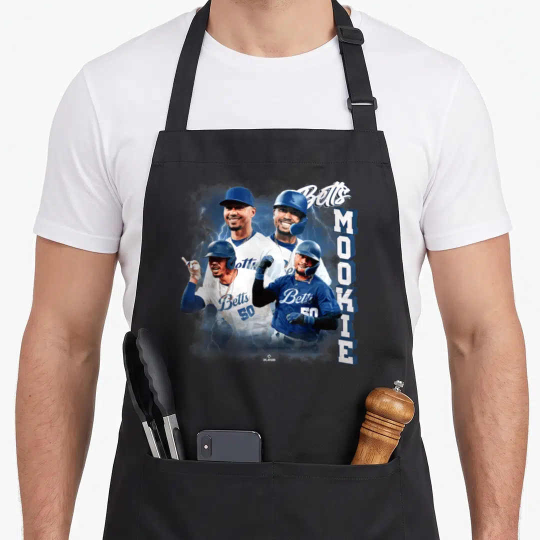Mookie baseball apron - Four Mookie Betts photos in blue white gear with vertical MOOKIE text and script Betts — shown on a black cotton canvas apron against a white background