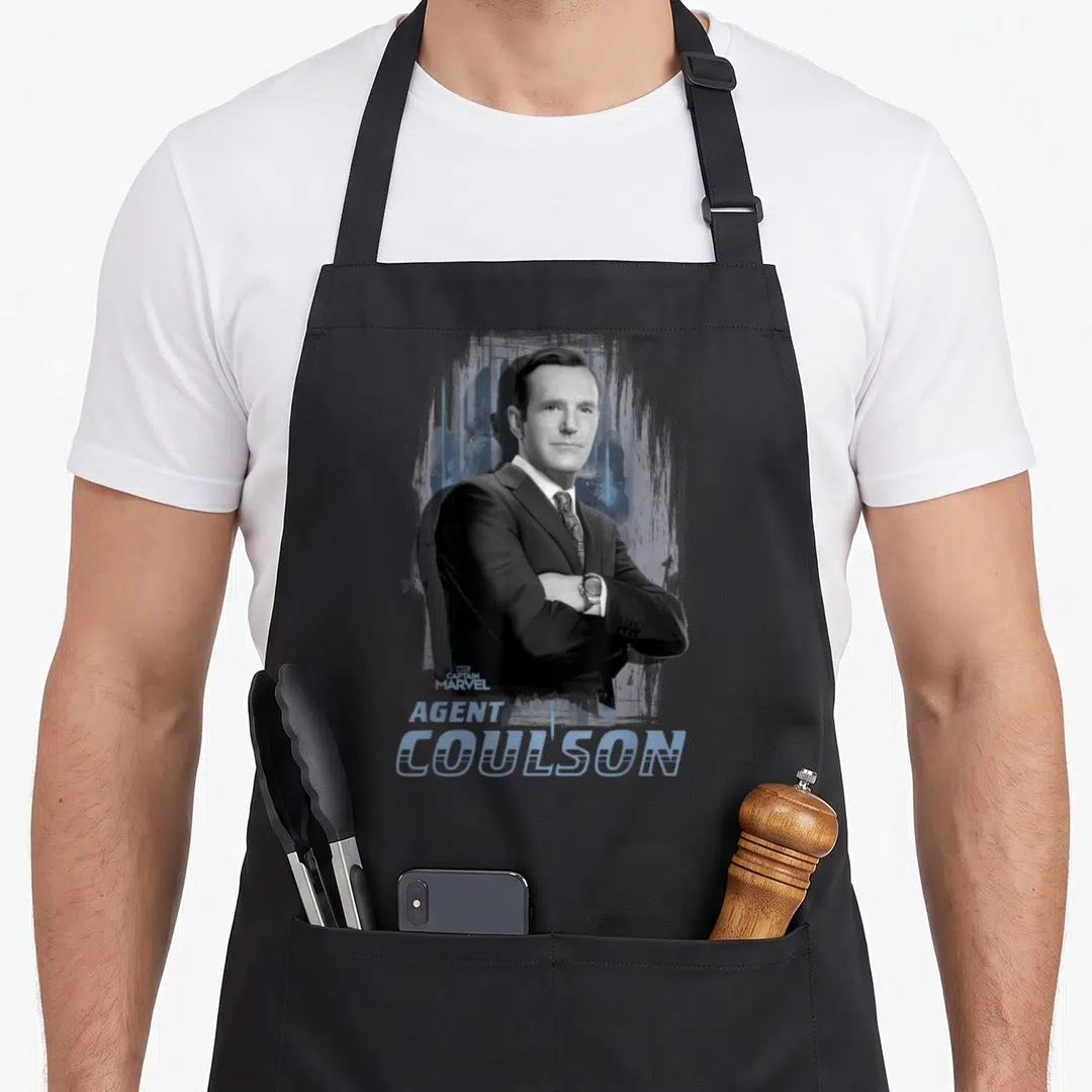 Agent captain apron - Photo of Agent Coulson in suit with blue splatter background and stacked text — shown on a black cotton canvas apron against a white background