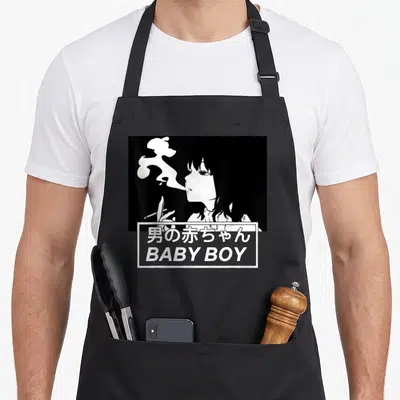 Baby anime apron - Woman smoking profile above box with Japanese text and BABY BOY in cartoon style — shown on a black cotton canvas apron against a white background