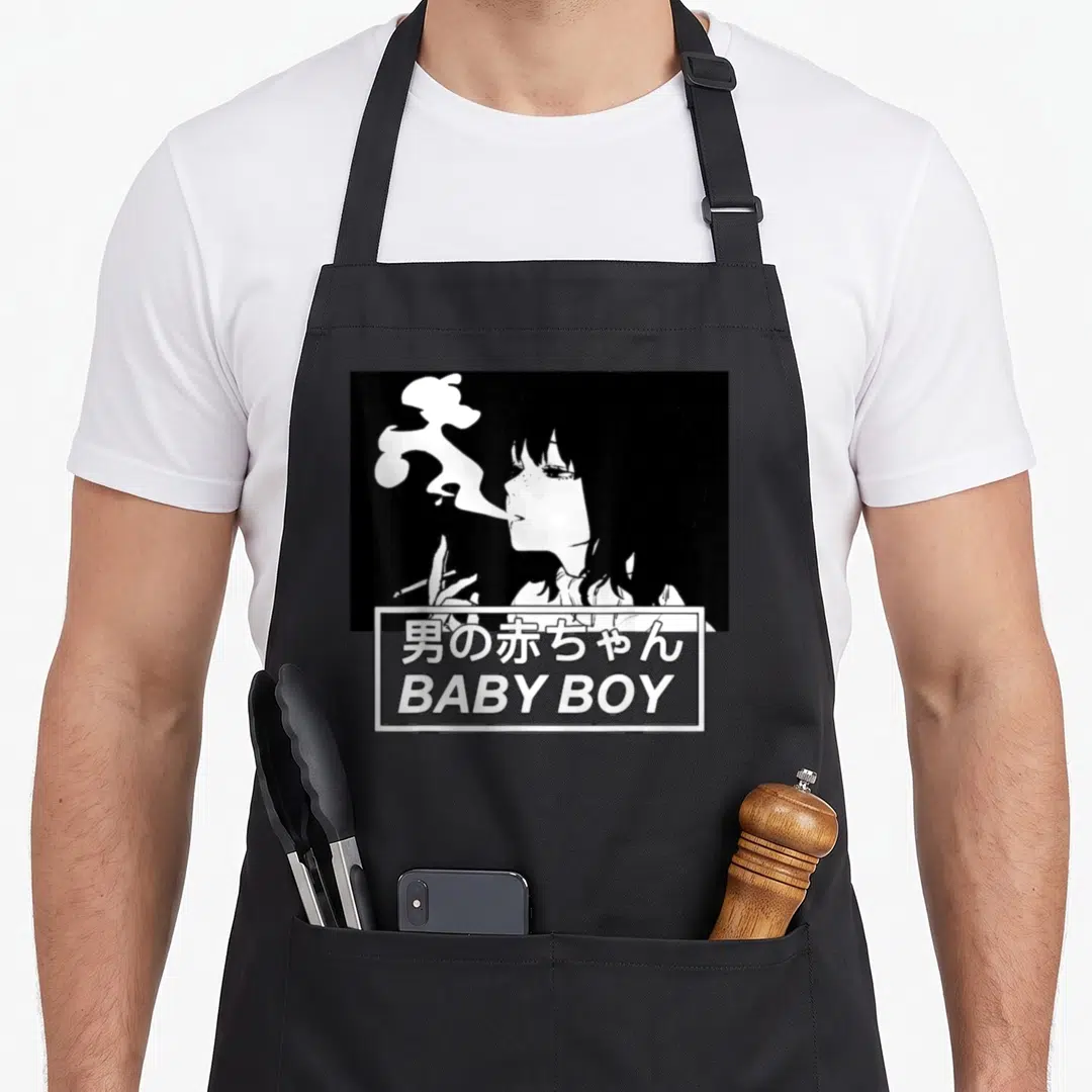 Baby anime apron - Woman smoking profile above box with Japanese text and BABY BOY in cartoon style — shown on a black cotton canvas apron against a white background