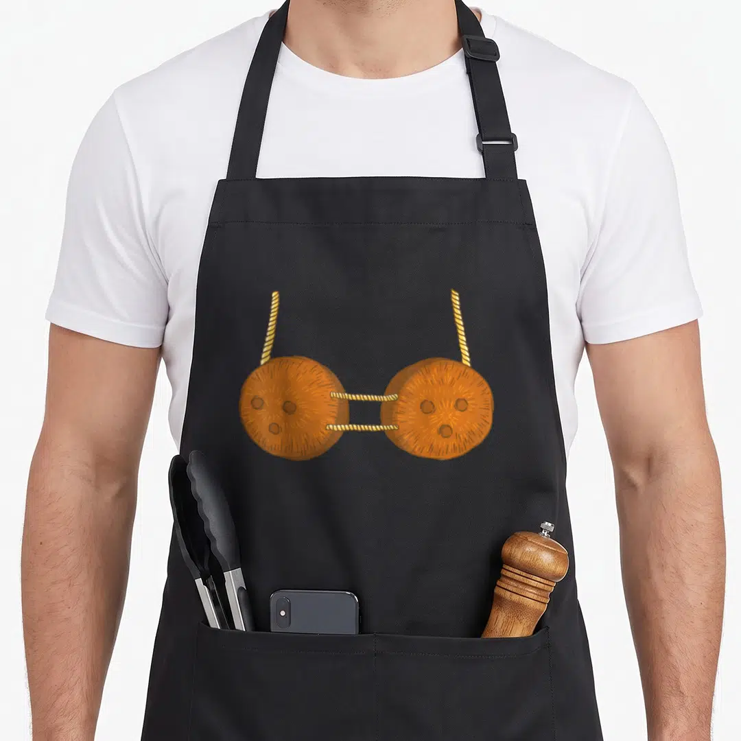 Coconut carnival apron - Two brown cartoon coconut shells connected by yellow twisted rope segments — shown on a black cotton canvas apron against a white background