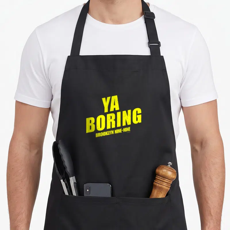 Boring brooklyn apron - Yellow stacked text reading YA BORING BROOKLYN NINE-NINE on black fabric — shown on a black cotton canvas apron against a white background