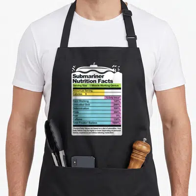 Funny submarine military apron - Submariner Nutrition Facts label with white submarine on water and colored rows — shown on a black cotton canvas apron against a white background
