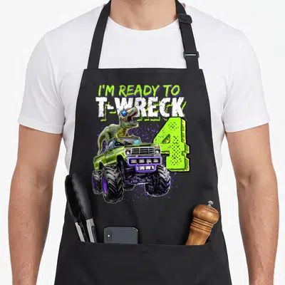 Wreck dinosaur truck apron - I'M READY TO T-WRECK 4 T-Rex monster truck cartoon print lime green — shown on a black cotton canvas apron against a white background