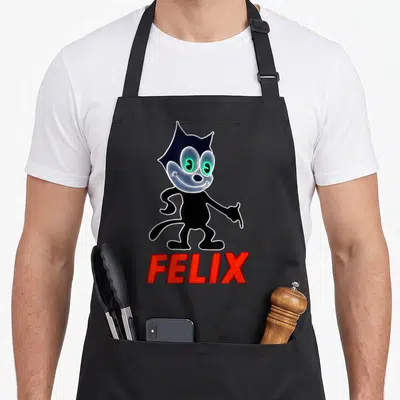 Glowing 1920s apron - Black cartoon cat with green eyes standing above red neon FELIX text — shown on a black cotton canvas apron against a white background