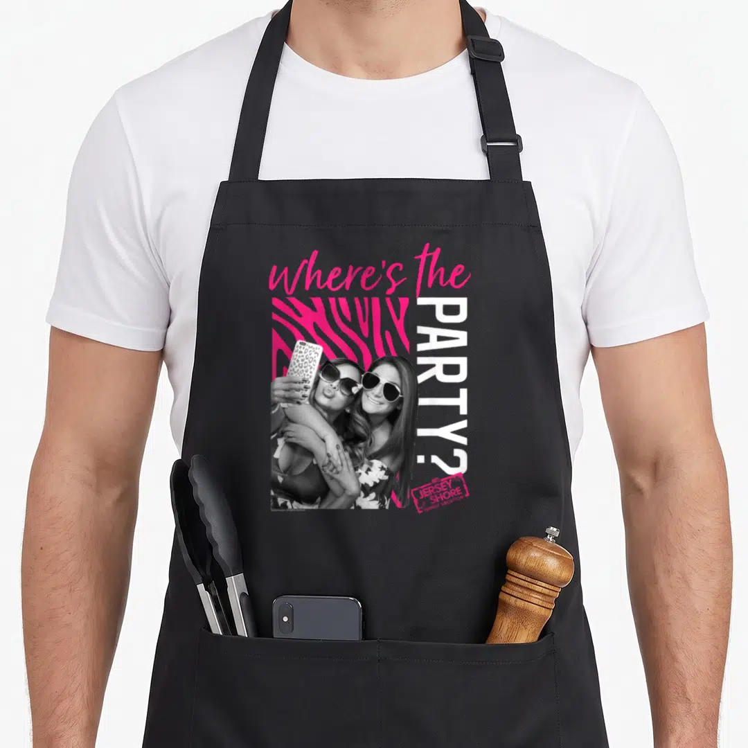 Jersey zebra apron - Two women selfie over pink zebra print with Where's the Party text — shown on a black cotton canvas apron against a white background