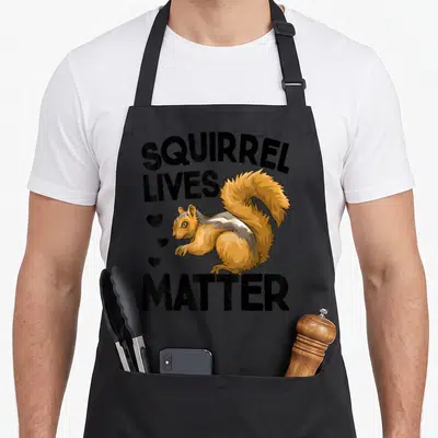 Live animal apron - Cartoon squirrel with SQUIRREL LIVES MATTER text and three hearts in orange brown and black — shown on a black cotton canvas apron against a white background