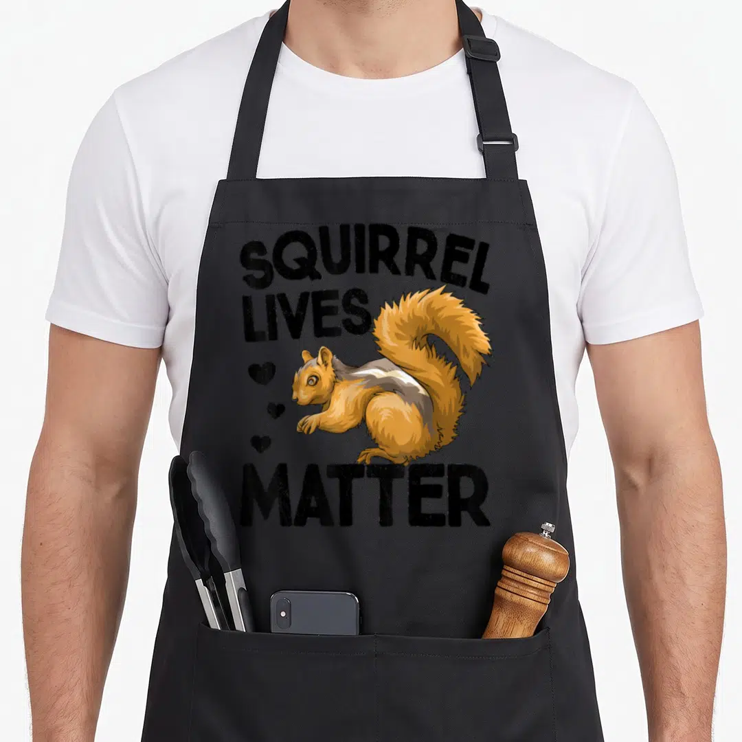 Live animal apron - Cartoon squirrel with SQUIRREL LIVES MATTER text and three hearts in orange brown and black — shown on a black cotton canvas apron against a white background
